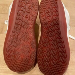 White Sneakers reddish brown soles.